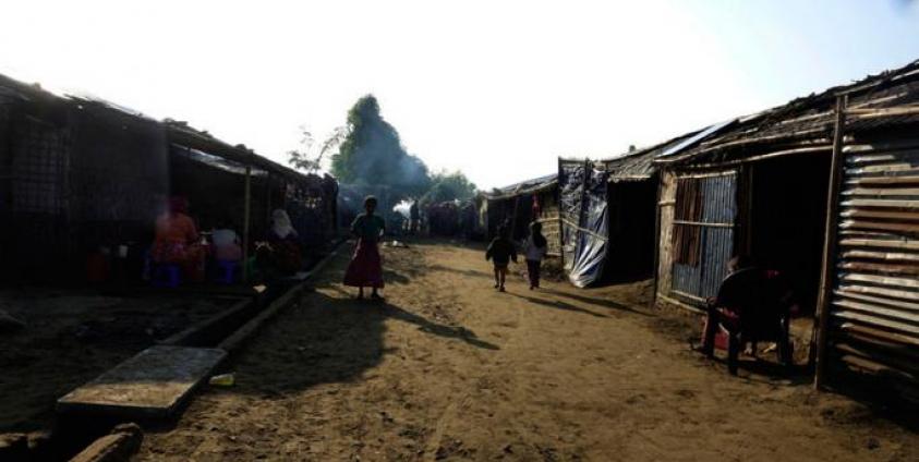 People walk around the Thet Kel Pyin internally displaced persons (IDP) camp in Sittwe, Rakhine State. Photo: EPA