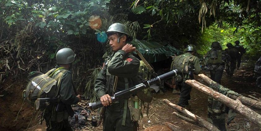 In this photograph taken October 14, 2016, armed rebels belonging to the Kachin Independence Army (KIA) ethnic group move towards the frontline near Laiza in Kachin state. Photo: Hkun Lat/AFP