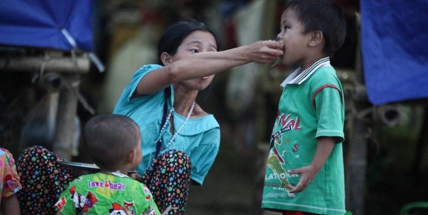 A mother feeding her baby at a refugee camp in Kachin State. Photo: Mizzima