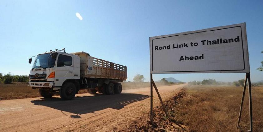 A truck passing a sign read "Road Link to Thailand Ahead" at Dawei Special Economics Zone