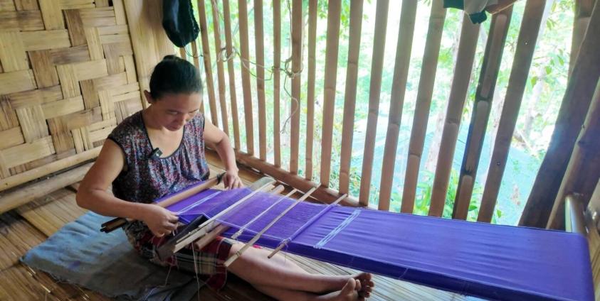 ကရင်အင်္ကျီဂါဝန်ရှည်ကို ရက်လုပ်နေတဲ့ နာယူဖောကို တွေ့ရစဉ်။