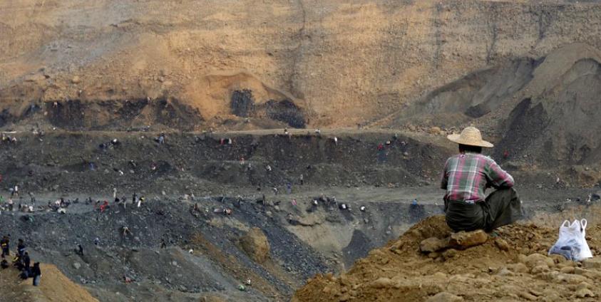 Miners search for jade stone near the heavy earth-excavators at the Hpa Kant jade mining area, Kachin State, northern Myanmar, 25 February 2017. Photo: La Min Tun/EPA