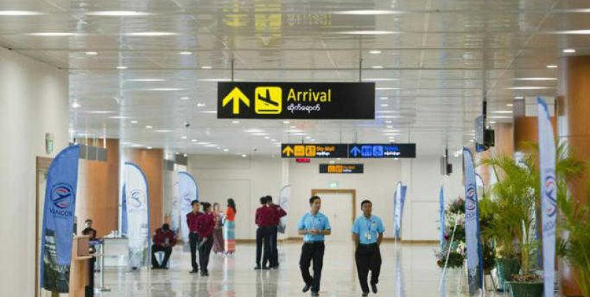 ရန်ကုန်လေဆိပ်အတွင်း သွားလာနေသူများ (Photo- AFP)