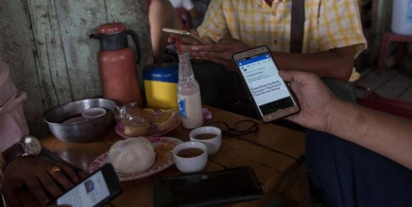 Myanmar people gather for refreshement at a teashop in Yangon many hangout to chat and browse Facebook with their mobile phone. Photo: Sai Aung Main/AFP