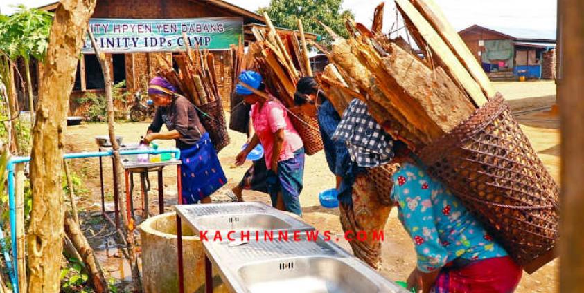 Women carrying firewood wash their hands at IDP camp of Trinity Kachin Baptist Church in Myitkyina, the capital of Kachin State, northern Burma.