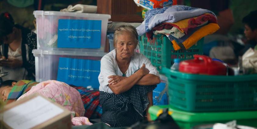 A old woman sits among piled up belongings of residents taking shelter inside a pagoda which is turned into a temporary evacuation center at Hpa-An Township in Kayin State, Myanmar, 02 August 2018. Photo: Lynn Bo Bo/EPA