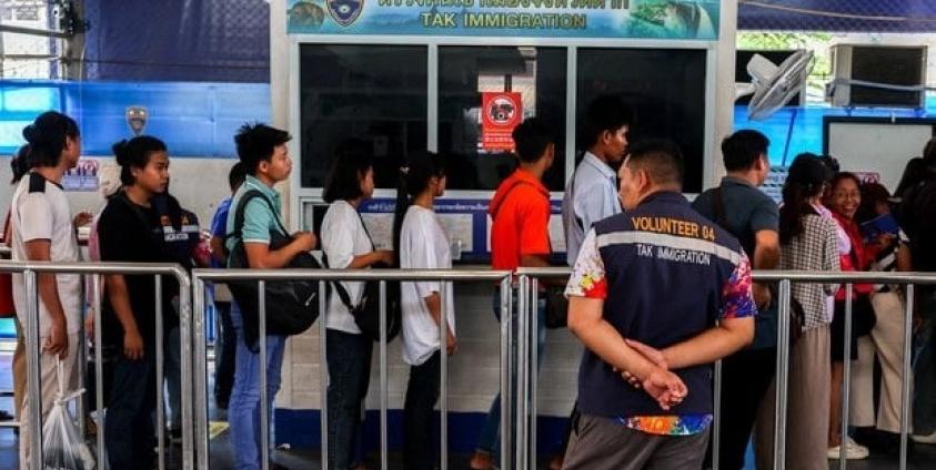 Burmese nationals crossing the Thai-Myanmar Friendship Bridge No. 1, which connects Mae Sot, Thailand, and Myawaddy, Myanmar, into Thailand, are seen in April 2024.