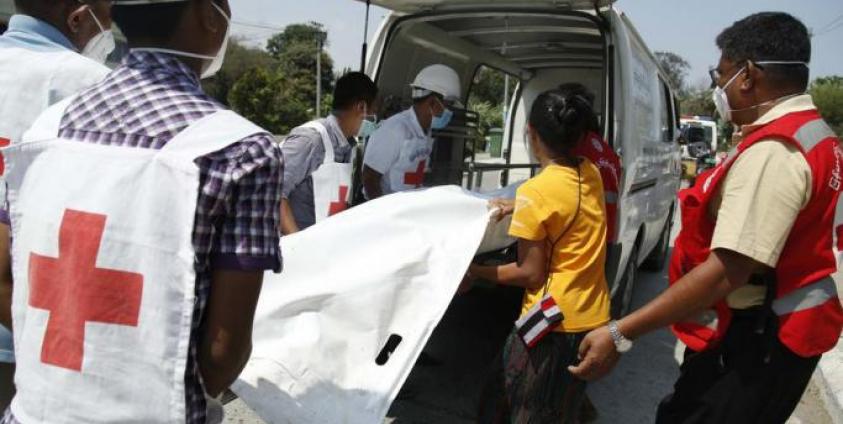 Members of the Myanmar Red Cross society move a dead body from a boat to an ambulance that will transport to Sittwe Hospital, in Sittwe, Rakhine State, western Myanmar, 21 April 2020. Photo: Nyunt Win/EPA
