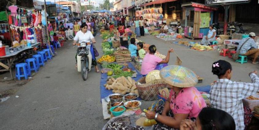 Residents buying food at a market in the town of Myitkyina, Kachin State. Photo: AFP