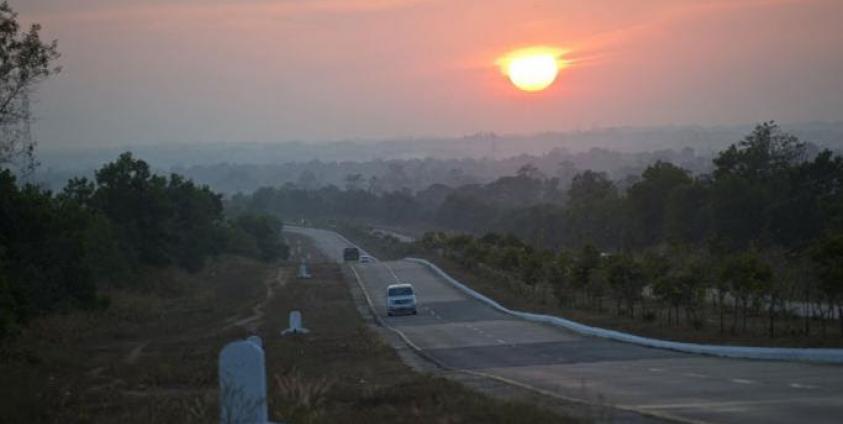 Commuters drive on a highway road on the outskirts of Yangon. Photo: Ye Aung Thu/AFP