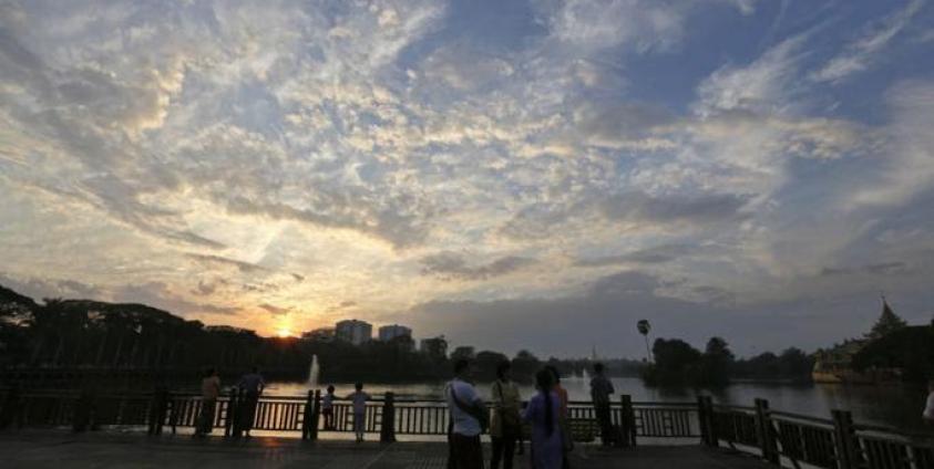 People watch the last sunset of the year at the Kandawgyi Park in Yangon. Photo: Nyein Chan Naing/EPA