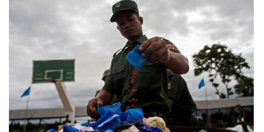 Member of the UWSA  empties a packet of 'WY' also know as Ya Ba before they are set on fire during a drug burning ceremony, near the Thai and Myanmar border on June 26, 2017. Photo: Ye Aung Thu/AFP