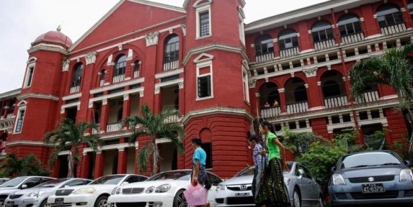 People walk in front of Yangon General Hospital in Yangon. Photo: Lynn Bo Bo/EPA