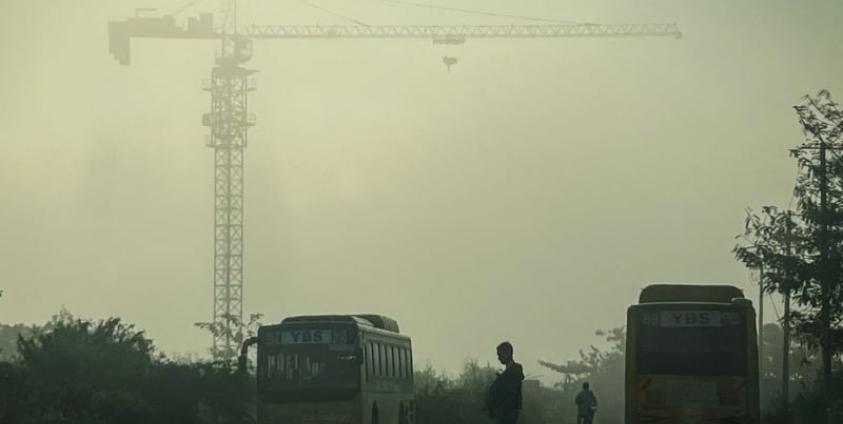 A man crosses a street amid high levels of air pollution in Yangon on January 27, 2025. (Photo by Sai Aung MAIN / AFP)