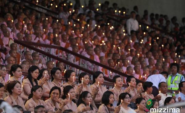 People hold candles during the Interreligious Gathering of Prayer for Peace ceremony at Yangon football stadium on 10 October 2017. Photo: Thura/Mizzima