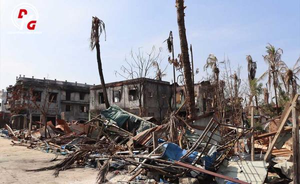 တိုက်ပွဲအတွင်း မီးလောင်ပျက်စီးသွားသည့် ပေါက်တောမြို့မှ နေအိမ်အဆောက်အအုံများအား ၂၀၂၄ ခုနှစ်၊ ဇန်နဝါရီလအတွင်း တွေ့ရစဉ်။