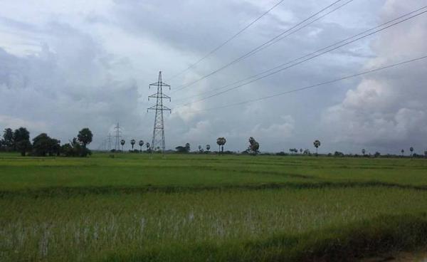Electricity towers and lines seen across local paddy fields (Photo: Naiaung Naing)