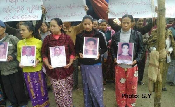 Protesters hold pictures of their abducted relatives during a protest in Mongwi village in Namkham Township. (Photo: S.Y.)