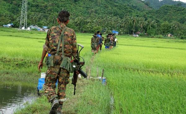 Myanmar soldiers walk in Chain Khar Li Rakhine ethnic village, an area close to fighting at Rathedaung township of northern Rakhine State, western Myanmar, 25 August 2017. Photo: Nyunt Win/EPA