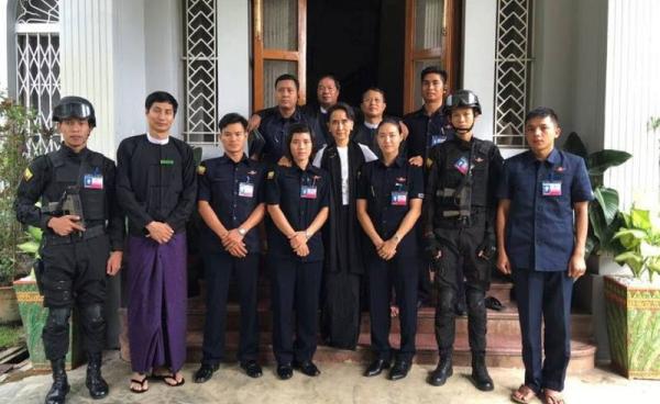 Myanmar State Counsellor and Foreign Minister Aung San Suu Kyi seen closely with security guards during 69th Martyrs' Day at her house in Yangon. Photo: Soe Win/Facebook