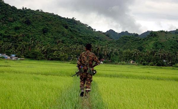 Myanmar soldier walks in Chain Khar Li Rakhine ethnic village, an area close to fighting at Rathedaung township of northern Rakhine State, western Myanmar, 25 August 2017. Photo: Nyunt Win/EPA
