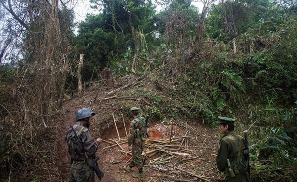 In this photograph taken October 13, 2016, armed rebels belonging to the Kachin Independence Army (KIA) ethnic group inspect the frontline after it was hit by a military bomb during two days of fighting with the Myanmar military near Laiza in Kachin State. Photo: Hkun Lat/AFP