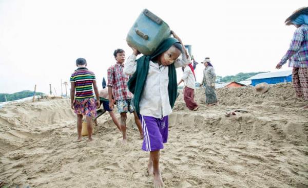 A young child carries sand, Hintada township, Ayeyawaddy region on 13 August 2015. Photo: Hong Sar/Mizzima