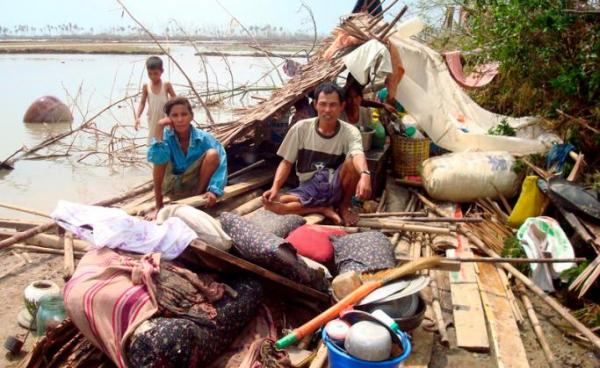 A Myanmar family sits on the remains of their house in Bogolay, the Irrawaddy Delta, 14 May 2008. Photo: EPA