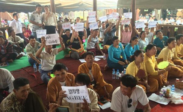  People Hold Signs Opposing the Dam Project
