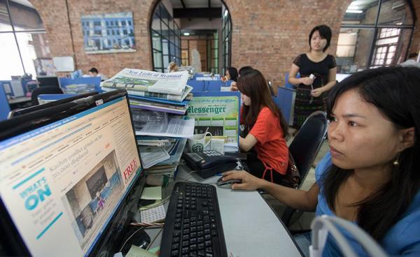 Journalists at work in the news room of of Myanmar Times weekly journal, Yangon, Myanmar. Photo: Lynn Bo Bo/EPA