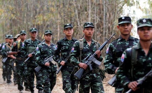 (File) Karen National Union (KNU) guerillas with their weapons parade. Photo: Rungroj Yongrit/EPA