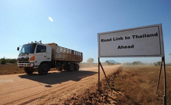 A truck passing a sign read "Road Link to Thailand Ahead" at Dawei Special Economics Zone