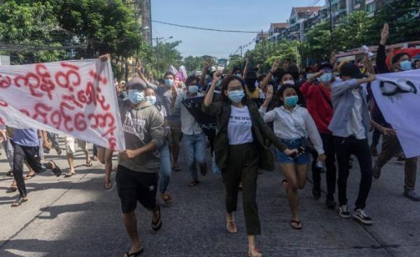 Photo: Protesters hold up banners and the three-finger salute during a demonstration against the military coup in Yangon on May 14, 2021. Photo: AFP