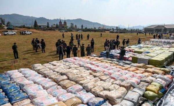 (File) Foreign military attaches check drugs in a football ground where seized drugs, vehicles, laboratory accessories and precursor chemicals are being displayed to be witnessed by invited military attaches and journalists in Kawnghka at Shan State on March 6, 2020. Photo: Ye Aung Thu/AFP