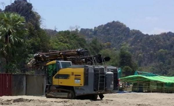 A machine levels the ground at the site of a cement factory in Kyaikmaraw township, Mon State