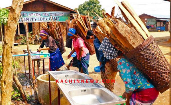 Women carrying firewood wash their hands at IDP camp of Trinity Kachin Baptist Church in Myitkyina, the capital of Kachin State, northern Burma.