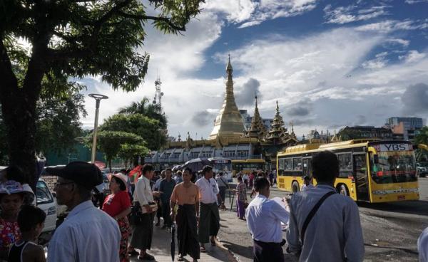 People walking in front of the Sulay Pagoda in downtown area of Yangon. Photo: Ye Aung Thu/AFP