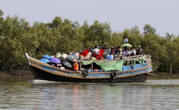 People travelling by boat in Sittwe, Rakhine State, western Myanmar. Photo: Nyein Chan Naing/EPA