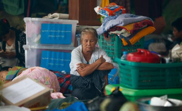 A old woman sits among piled up belongings of residents taking shelter inside a pagoda which is turned into a temporary evacuation center at Hpa-An Township in Kayin State, Myanmar, 02 August 2018. Photo: Lynn Bo Bo/EPA
