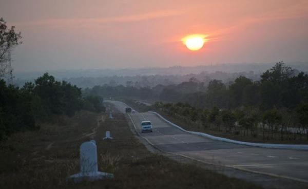 Commuters drive on a highway road on the outskirts of Yangon. Photo: Ye Aung Thu/AFP