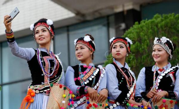 Lisu ethnic women take a selfie during celebrations of the New Year Countdown in Yangon, Myanmar, 31 December 2018. Photo: Nyein Chan Naing/EPA