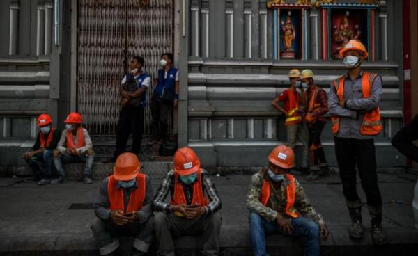 Construction workers gather during a protest to demand recognition of their labour rights, as some said they did not receive their full wages, in Yangon. Photo: AFP