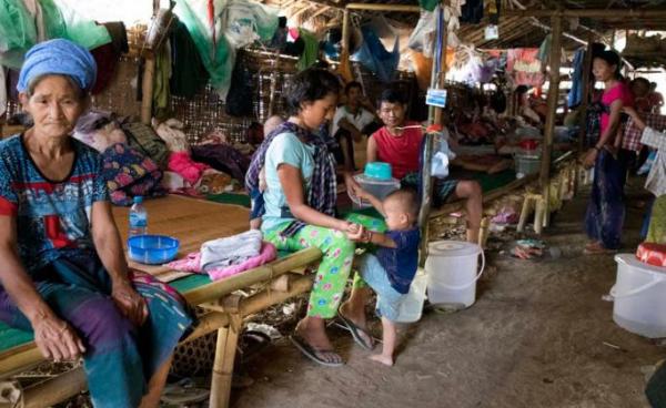 Caption : Internally displaced Kachin ethnic people sit inside a temporary refugee camp at Tan Phae village Roman Catholic church in Myitkyina, Kachin State, northern Myanmar. Photo: Seng Mai/EPA