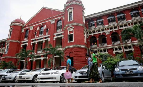 People walk in front of Yangon General Hospital in Yangon. Photo: Lynn Bo Bo/EPA