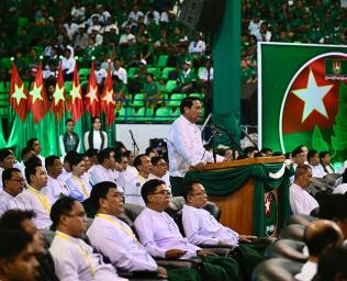 Chairman of the Myanmar military-backed Union Solidarity and Development Party (USDP) Khin Yi speaks during an election campaign event in Yangon on November 19, 2025. Myanmar junta has touted polls starting December 28 as a path to peace, but the vote will be blocked from rebel-held enclaves and monitors are dismissing it as a ploy to disguise continuing military rule. (Photo by Sai Aung MAIN / AFP) 